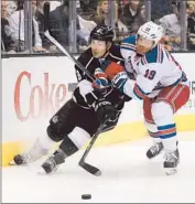  ?? Victor Decolongon Getty Images ?? BRAD RICHARDS (19) of the Rangers checks Kings defenseman Drew Doughty in the first period.