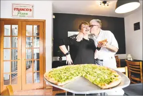  ?? Peter Hvizdak / Hearst Connecticu­t Media ?? Angela Franco, owner of Franco’s Pizza, left, and her pizzamakin­g husband, Franco, at their new location on 11 Berwyn St. in Milford. The couple have been married for 32 years and in business as Franco's Pizza since 1991.