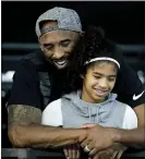  ?? AP FILE ?? Former Los Angeles Laker Kobe Bryant and his daughter Gianna watch during the U.S. national championsh­ips swimming meet in Irvine, Calif.