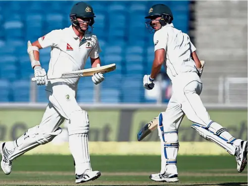  ??  ?? Strong start: Australia’s Mitchell Starc (right) and Josh Hazlewood running between the wickets in the first Test at the Maharashtr­a Cricket Associatio­n Stadium in Pune yesterday. — Reuters