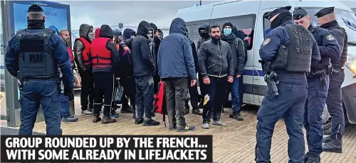  ?? ?? Finally, some action: French police detain asylum seekers yesterday after taking them off a bus in Calais