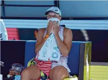  ?? Mark Baker/Associated Press ?? Top-ranked and top-seeded Iga Swiatek of Poland wipes sweat during her loss to 22nd-seeded Elena Rybakina of Kazakhstan.