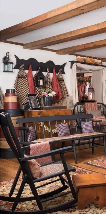  ??  ?? Right: The sunroom’s recycled barnwood posts and beams give the new addition character. The hues of the structural supports, sofa and baskets pair beautifull­y with the dark wood furniture. A bit of red, introduced via fabric elements and other accents, enlivens the space.