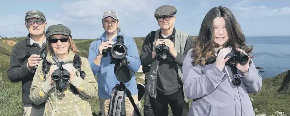  ??  ?? Looking for the elusive visitor are local bird-watchers Roger Barns, Judith Gombocz, Tony Hood, Steve Gombocz and Jo Hood. Picture by Paul Atkinson. Inset: 12-year-old Joe Fryer