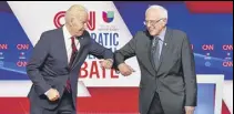  ?? REUTERS ?? Joe Biden and Bernie Sanders do an elbow bump before the start of the Democratic candidates’ debate on Sunday.