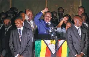  ?? BEN CURTIS / ASSOCIATED PRESS JAPAN ?? Emmerson Mnangagwa, Zimbabwe’s incoming president (center), greets supporters gathered outside the ZANU-PF party headquarte­rs in Harare, Zimbabwe, on Wednesday.