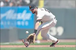  ??  ?? Bryant (23) reaches for a grounder and throws out Houston Astros’ Aledmys Díaz (16) at first base in the second inning of their game at Oracle Park in San Francisco on Aug. 1.