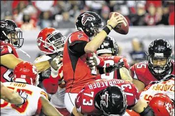  ?? HYOSUB SHIN / HSHIN@AJC.COM ?? Quarterbac­k Matt Ryan (above, getting brought down Sunday by Kansas City’s Tamba Hali) has only seven intercepti­ons this year, but four of them came in the fourth quarter of games in which the Falcons blew a lead.