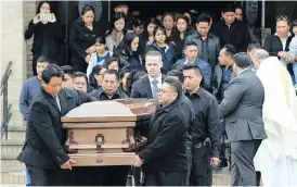  ?? FRANK ELTMAN / THE ASSOCIATED PRESS FILES ?? The casket of Justin Llivicura is carried from St. Joseph the Worker Church after his funeral in East Patchogue, N.Y. Llivicura, 16, was one of four young men found slain in a suspected MS-13 gang killing in a park in Central Islip, N.Y., on April 12.