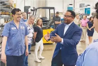  ?? AP PHOTO/SARA BURNETT ?? Republican candidate for Illinois governor Richard Irvin speaks with employees during a tour of HM Manufactur­ing Inc. in June in Wauconda, Ill.