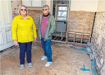  ??  ?? DEVASTATED: Kate and Steve Hampshaw of Kinglassie saw part of their house washed away when the Lochty Burn broke its banks during the storm. Picture by Steve Brown.