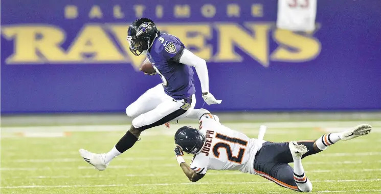  ?? — THE ASSOCIATED PRESS ?? Ravens QB Robert Griffin III, left, was one of the first quarterbac­ks to employ run-pass option plays in the NFL when he was a rookie with Washington.