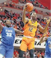  ??  ?? Oklahoma State’s Cameron McGriff catches the ball between Florida Gulf Coast’s Antravious Simmons and Zach Johnson during Tuesday’s NIT basketball game between Oklahoma State University and Florida Gulf Coast at Gallagher-Iba Arena in Stillwater.