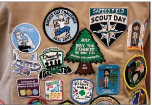  ?? AP/ELAINE THOMPSON ?? A Girl Scout shows off the patches on her vest recently. The Girl Scouts of the United States of America has filed suit against the Boy Scouts of America for dropping the word “boy.”