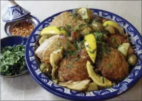  ?? SARA MOULTON VIA AP ?? Couscous with baked chicken, green olives, lemons and artichoke hearts.