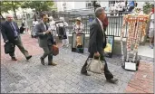  ?? Associated Press ?? Lawyers walk by protesters gathered outside a courthouse on Aug. 2 in Boston, where a judge was to hear arguments in Massachuse­tts’ lawsuit against Purdue Pharma over its role in the national drug epidemic.