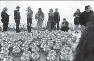  ?? YASMINA CHAVEZ ?? Guests take in Yayoi Kusama’s installati­on “Narcissus Garden” while waiting to experience her “Infinity Room: Aftermath of Obliterati­on of Eternity,” at the Bellagio Gallery of Fine Art.