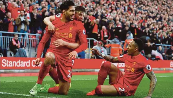  ??  ?? Liverpool’s Emre Can (left) celebrates his goal against Burnley in their Premier League match on Sunday.