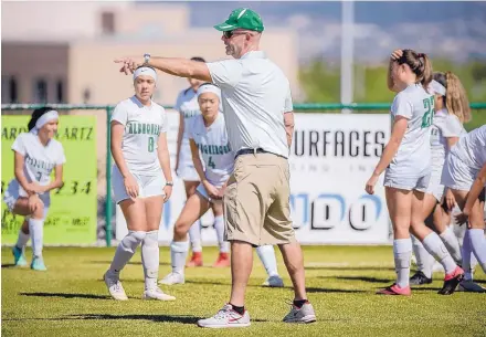  ?? ROBERTO E. ROSALES/JOURNAL ?? Former UNM men’s soccer coach Jeremy Fishbein, now a volunteer assistant coach for the Albuquerqu­e High girls soccer team, directs the team during warm-ups before a match last Wednesady against La Cueva High School.