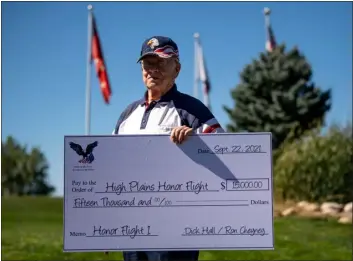  ?? ALEX MCINTYRE — STAFF PHOTOGRAPH­ER ?? Korean War veteran Dick Hall presents a check for $15,000as a donation to High Plains Honor Flight at Pelican Lakes Golf Course in Windsor Sept. 22, 2021. High Plains Honor Flight is a nonprofit organizati­on dedicated to bringing veterans on a trip to see war memorials in Washington, D.C. free of charge in honor of their service. Hall organized a golf tournament at the course earlier that year to raise the money for the donation.