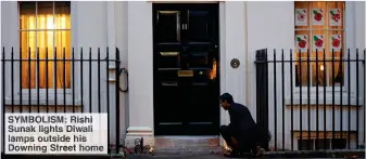  ??  ?? SYMBOLISM: Rishi Sunak lights Diwali lamps outside his Downing Street home