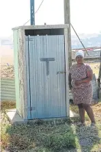  ?? PICTURES: BONGANI FUZILE ?? SO WHAT’S NEW? Aphiwe Seti, of Drayini village in the Mbashe municipali­ty, shows off a new toilet structure, left, that was recently built for her family, and their old toilet which was torn down but which they have rebuilt.