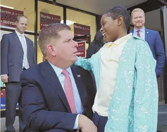  ?? STAFF PHOTO, ABOVE, BY ANGELA ROWLINGS, RIGHT, BY CHRIS CHRISTO ?? STARTING KIDS YOUNG: The battle between Mayor Martin J. Walsh and Tito Jackson ends today. Walsh, above, talks with Aniyah Albert, 7, of Roxbury outside his Jamaica Plain campaign office yesterday. Jackson, left, high fives Mateo Burbano, 4, while...