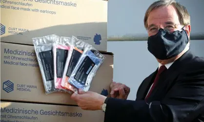  ?? Photograph: Sascha Steinbach/EPA ?? Armin Laschet, prime minister of North Rhine-Westphalia, with medical-grade face masks at a factory in Troisdorf.