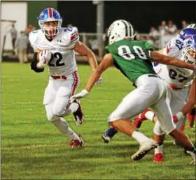  ?? RANDY MEYERS — THE MORNING JOURNAL ?? Bay running back Trey Psota turns the corner on Thomas Horne of Elyria Catholic and scores the game’s first touchdown during the first quarter.