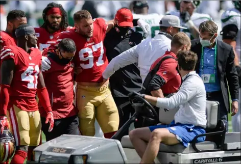  ?? AP PHOTO/BILL KOSTROUN ?? San Francisco 49ers defensive end Nick Bosa (97) is helped off the field after being injured during the first half of an NFL football game against the New York Jets, Sunday, in East Rutherford, N.J.