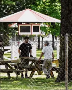  ?? ?? Picnic tables are put in place at Saratoga Race Course.