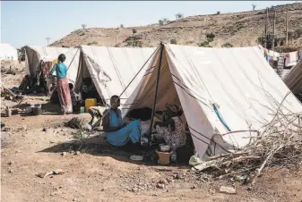  ?? Yasuyoshi Chiba / AFP via Getty Images ?? Ethiopian refugees live in tents at a camp in eastern Sudan. Tigray region remains cut off from the world, without nearly enough food and medicines needed by the population of 6 million.