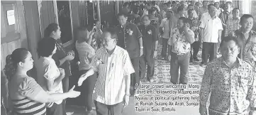  ??  ?? A large crowd welcoming Mong (third left), followed by Majang and Nyalau at political gathering held at Rumah Sulang Ak Arah, Sungai Tajan in Suai, Bintulu.