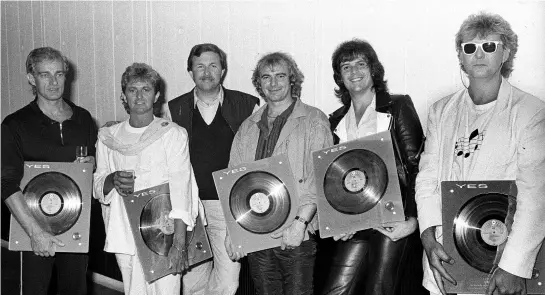  ??  ?? GOLD STANDARD: YES ON JULY 1, 1984, L-R: ALAN WHITE, JON ANDERSON, HANS TONINO (OF WEA/ WARNER RECORDS), TONY KAYE, TREVOR RABIN AND CHRIS SQUIRE.