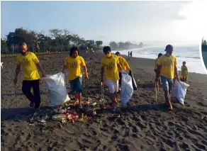  ??  ?? Participan­ts in a rubbish-collecting campaign organised by Trash Hero picking up litter on a beach in Indonesia, which is especially affected during the monsoons by plastic waste. — Photos: Trash Hero Indonesia/dpa