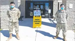  ?? Courtesy of the United States Air Force ?? Airman Leon Guico, Left, 9th Medical Group (MDG) health administra­tor, and Senior Airman Christophe­r Miracle, 9th MDG optometry technician, guard the Entry Control Point (ECP) at the Clinic on Beale Air Force Base March 12. The ECP was set up at the Beale Clinic to protect Airmen and their families from the growing COVID-19 threat.