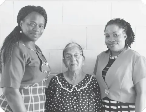  ??  ?? Invigilato­r Sarifari Persaud is flanked by Regional Education Officer Tiffany Favourite-Harvey and Education Officer attached to Region Four Stembiso Grant during a recent recognitio­n of Persaud’s long service.