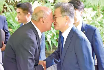  ??  ?? A supplied image shows Moon receiving a traditiona­l New Zealand Maori greeting called a Hongi from Piri Sciascia during a visit to Government House in Auckland, New Zealand. — Reuters photo