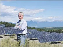  ?? CITY OF KIMBERLEY ?? Kimberley Mayor Don McCormick stands in front of SunMine solar panels. Since June, the experiment­al facility has delivered enough electricit­y to BC Hydro to power about 275 homes.