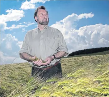  ?? ?? DEDICATED: Mr Smith among the barley on his farm at Auchnagatt, Ellon.