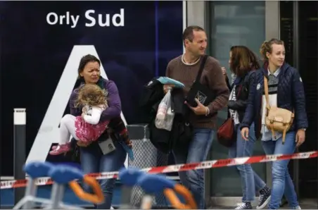  ?? KAMIL ZIHNIOGLU — THE ASSOCIATED PRESS ?? Travelers evacuate Orly airport, south of Paris, Saturday, March, 18. Soldiers at Paris’ busy Orly Airport shot and killed a man who wrestled one of their colleagues to the ground and tried to steal her rifle Saturday, officials said.