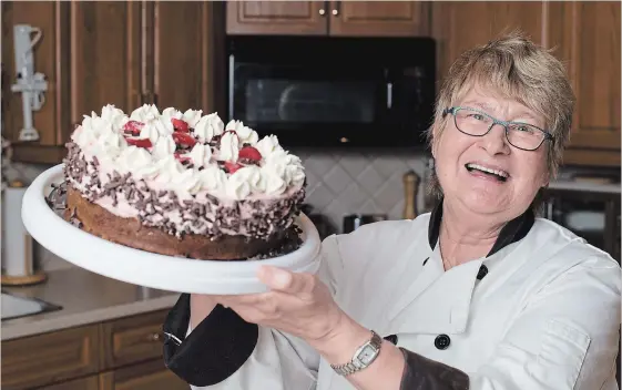  ?? PETER LEE WATERLOO REGION RECORD ?? Cookbook author Christa Battistone holds a beautiful strawberry mousse cake she made in her home.