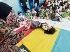  ??  ?? A child from the centre ‘Stops, Drops and Rolls” during the fire safety demonstrat­ion.