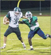  ?? PHOTO BY ALEX SCHLOGEL ?? Patuxent quarterbac­k Dylan Lovett tries to find some running room while being pursued by Jevon Hamilton of St. Charles during the teams’ game at St. Charles on Friday night. The host Spartans came out on top of a 14-8 decision.