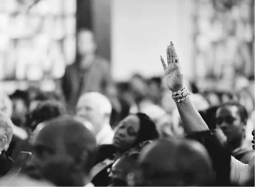  ?? Grac e Beahm / The Post And Courier via The Associat ed Press ?? A prayer vigil is held at Morris Brown AME Church for the victims of Wednesday’s shooting at Emanuel AME Church on Thursday, in Charleston, S.C. Dylann Storm Roof, 21, was arrested in the slayings of nine people, including the pastor.