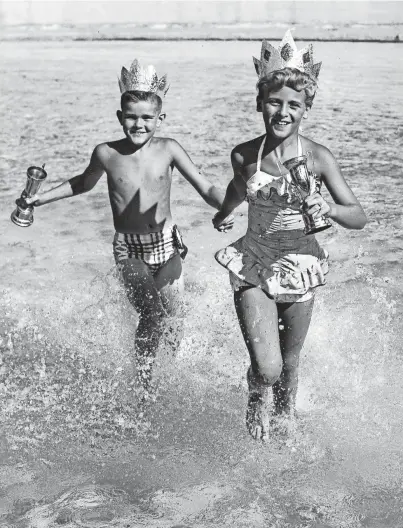  ?? THE COMMERCIAL APPEAL ?? Tops among wading pool contestant­s for the title of Master and Miss Memphis were Stephen Parks, 7, and Carole Mccants, 10. They received their crowns and trophies at the wading pool revue on July 21, 1956, at Overton playground.