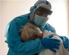  ?? — AFP ?? It’s okay: The viral photo of Dr Varon hugging the upset patient in the Covid-19 ICU at United Memorial Medical Centre in Houston.