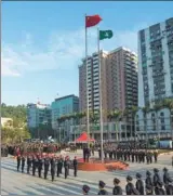  ?? ZHANG JINJIA / XINHUA ?? A flag-raising ceremony is held in Macao on Wednesday to celebrate the 18th anniversar­y of the special administra­tive region’s return to the motherland.