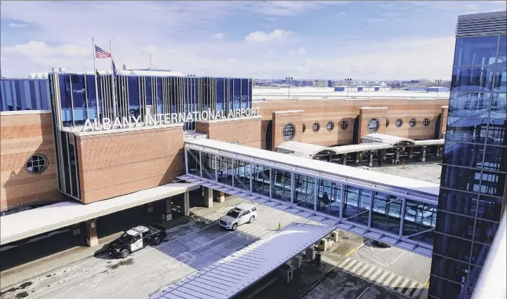  ?? Paul Buckowski / Albany Times Union ?? A plan at Albany Internatio­nal Airport calls for expanding a section of the front of the terminal out across the road and relocating escalators so travelers have more space through security.