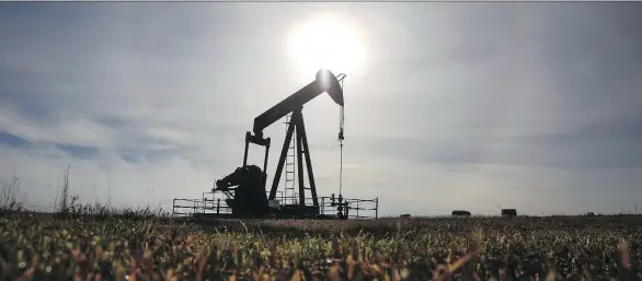  ?? JEFF MCINTOSH/THE CANADIAN PRESS FILES ?? A pumpjack works at a wellhead on an oil and gas installati­on near Cremona, Alta. The National Energy Board’s report forecasts domestic oil production will grow by 58 per cent and natural gas production will grow 29 per cent between now and 2040, while domestic energy demand will increase by just five per cent — or less.